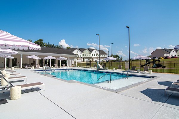 Rooftop pool with loungers at Summerwell Parkway Village Apartments for luxury relaxation