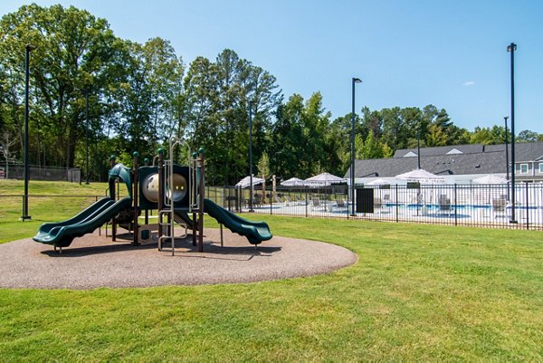 Outdoor playground at Summerwell Parkway Village Apartments featuring modern play equipment