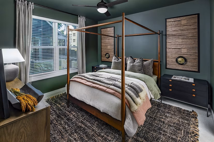 Cozy bedroom with modern furnishings at Milo Apartments