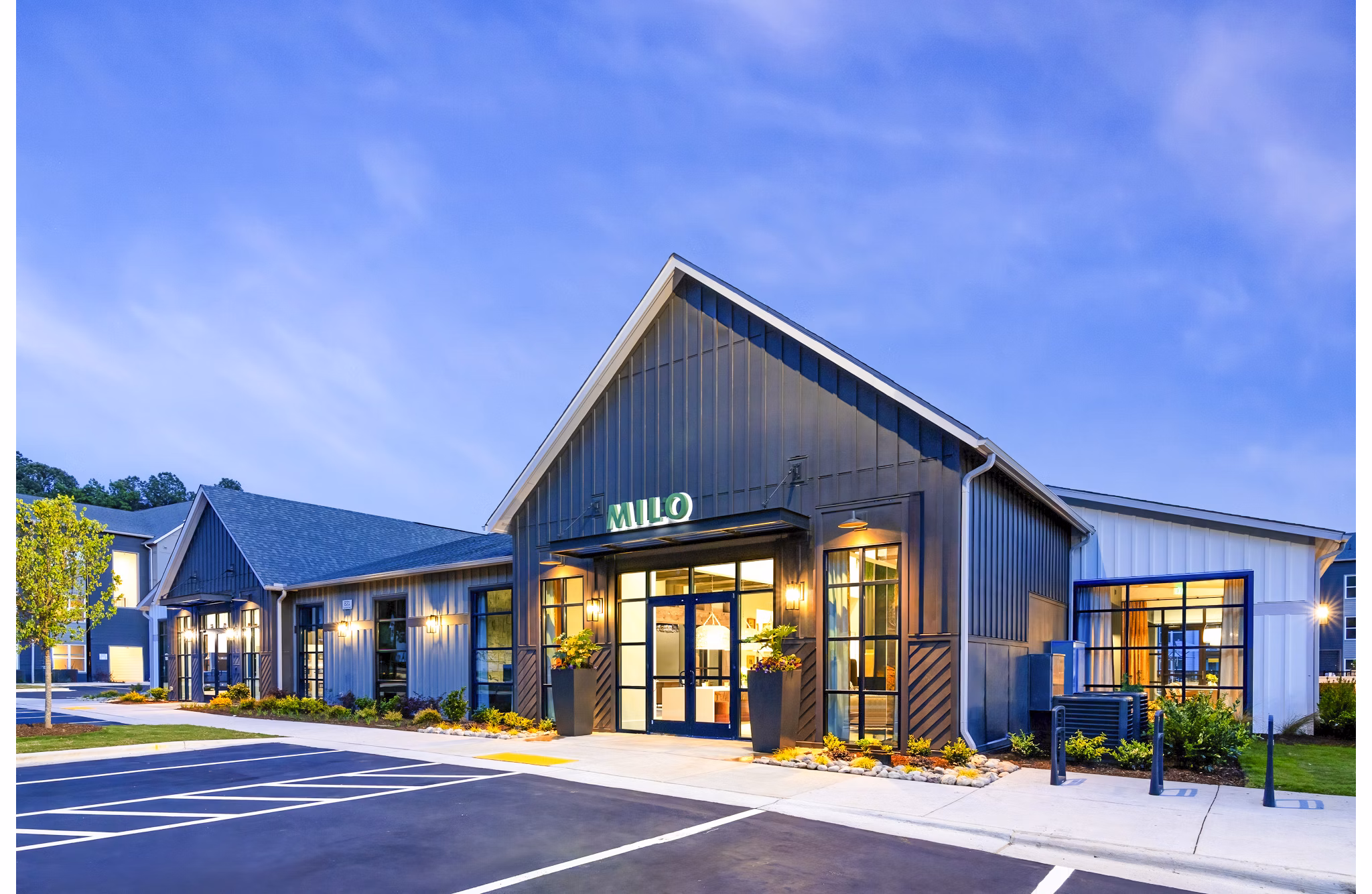 Stylish clubhouse with modern lounge and game area at Milo Apartments, offering luxury living