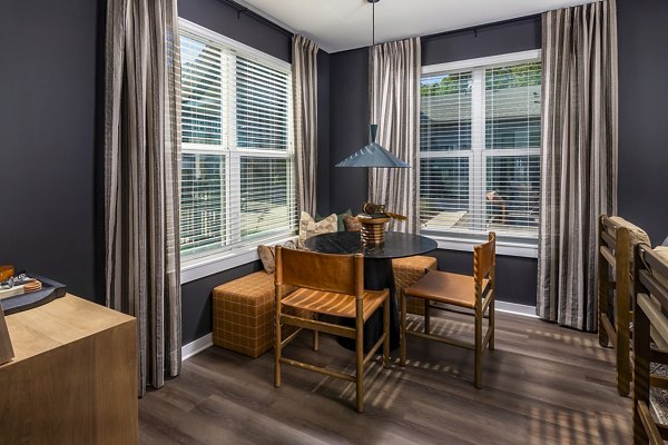 Dining room with modern decor and chic lighting at Milo Apartments, luxury living by Greystar