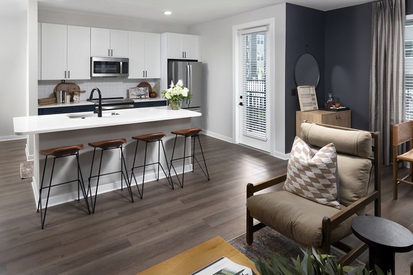 Milo Apartments: Sleek kitchen featuring modern appliances and quartz countertops