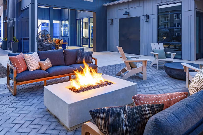 Milo Apartments: Cozy patio with a modern fire pit, perfect for relaxation