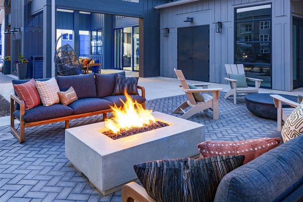 Milo Apartments: Cozy patio with a modern fire pit, perfect for relaxation