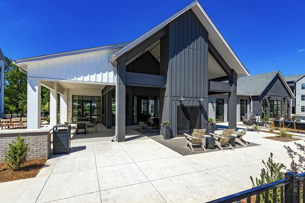 Patio with seating and lush greenery at Milo Apartments, offering a relaxing outdoor space