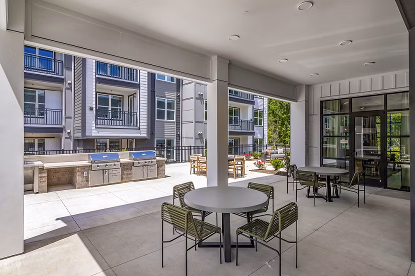 Grill area on modern patio at Milo Apartments, ideal for outdoor gatherings and relaxation