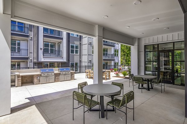 Grill area on modern patio at Milo Apartments, ideal for outdoor gatherings and relaxation