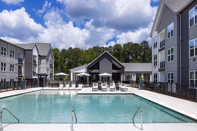 Resort-style pool with lounging area at Milo Apartments, offering Greystar luxury amenities in a vibrant community setting