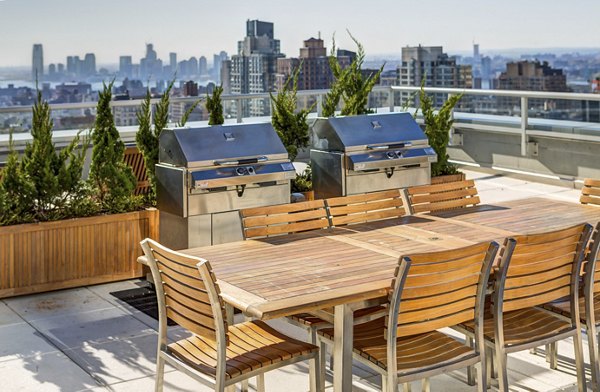 Outdoor grilling area with modern seating at The Dylan Apartments, a luxury property by Greystar in vibrant neighborhood