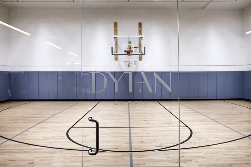 Outdoor sport court for basketball and tennis at The Dylan Apartments offers recreation facilities for residents