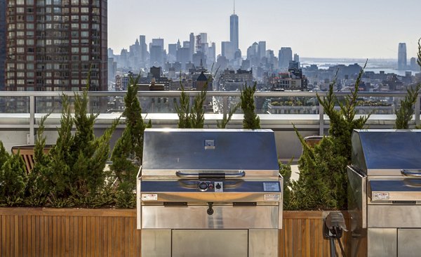 Outdoor grill area with modern seating at The Dylan Apartments offering luxury outdoor living spaces