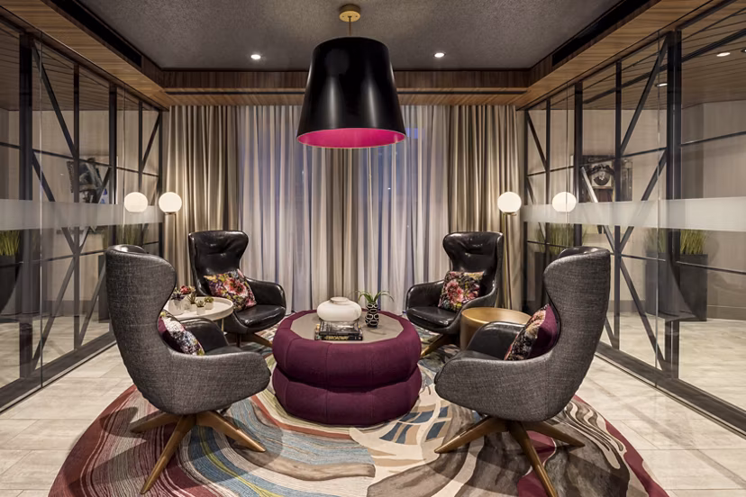 The Octagon Apartments: Modern clubhouse with ample seating and floor-to-ceiling windows on Roosevelt Island