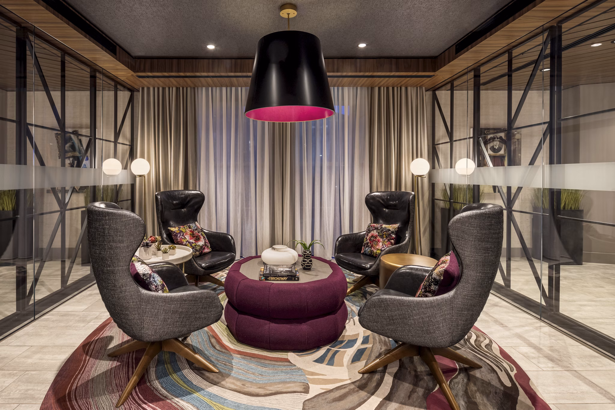 The Octagon Apartments: Modern clubhouse with ample seating and floor-to-ceiling windows on Roosevelt Island