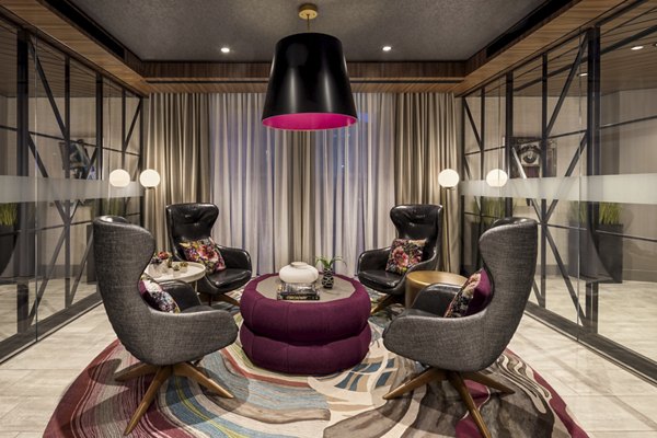 The Octagon Apartments: Modern clubhouse with ample seating and floor-to-ceiling windows on Roosevelt Island