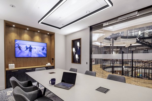 The Octagon Apartments: Modern clubhouse business center with sleek design and technology in a luxury setting