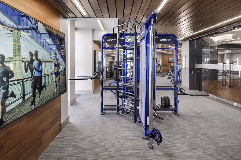 State-of-the-art fitness center at The Octagon Apartments with modern equipment and spacious workout area, perfect for luxury living