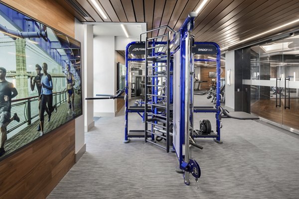 State-of-the-art fitness center at The Octagon Apartments with modern equipment and spacious workout area, perfect for luxury living