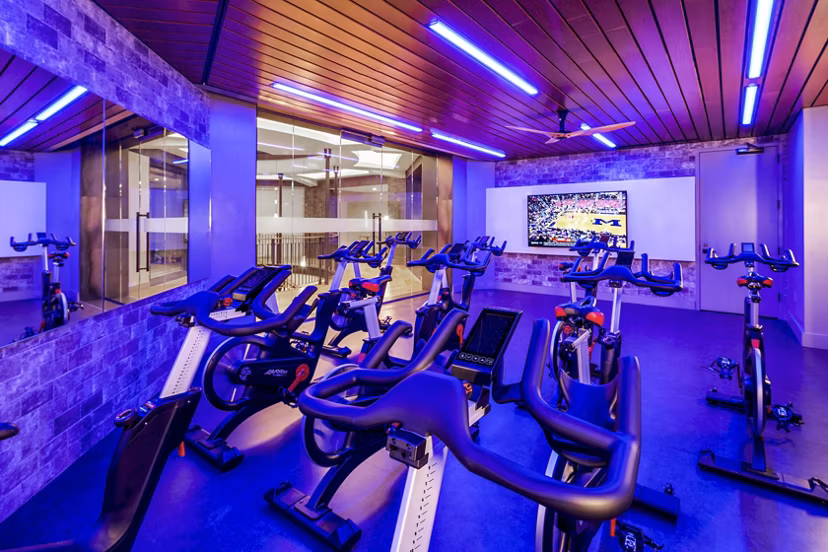 State-of-the-art spin studio with modern bikes at The Octagon Apartments, offering dynamic fitness sessions for residents