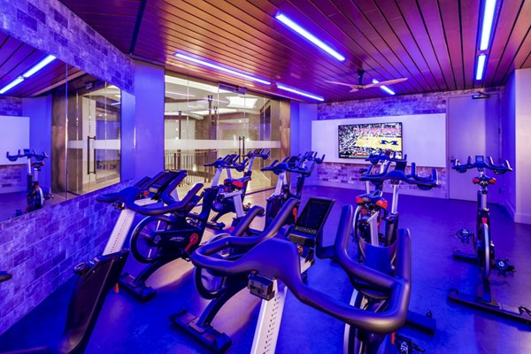 State-of-the-art spin studio with modern bikes at The Octagon Apartments, offering dynamic fitness sessions for residents