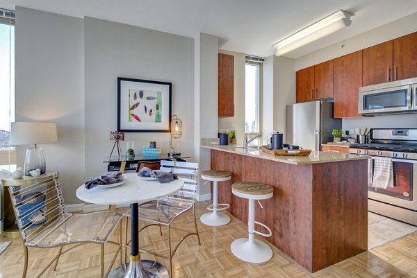 Modern dining room and kitchen with sleek finishes at The Octagon Apartments
