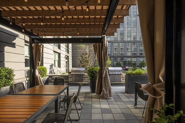 Outdoor grill area at The Octagon Apartments featuring spacious patio and modern amenities, perfect for entertaining and relaxation