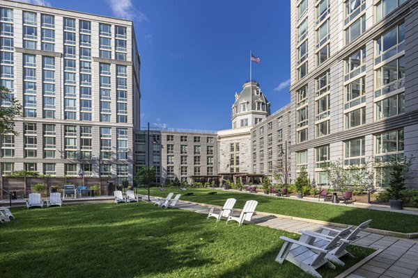 The Octagon Apartments: Tranquil courtyard patio with lush landscaping and seating areas, perfect for relaxation and outdoor gatherings
