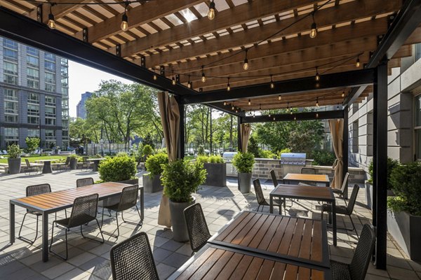 Outdoor grilling patio with modern seating at The Octagon Apartments