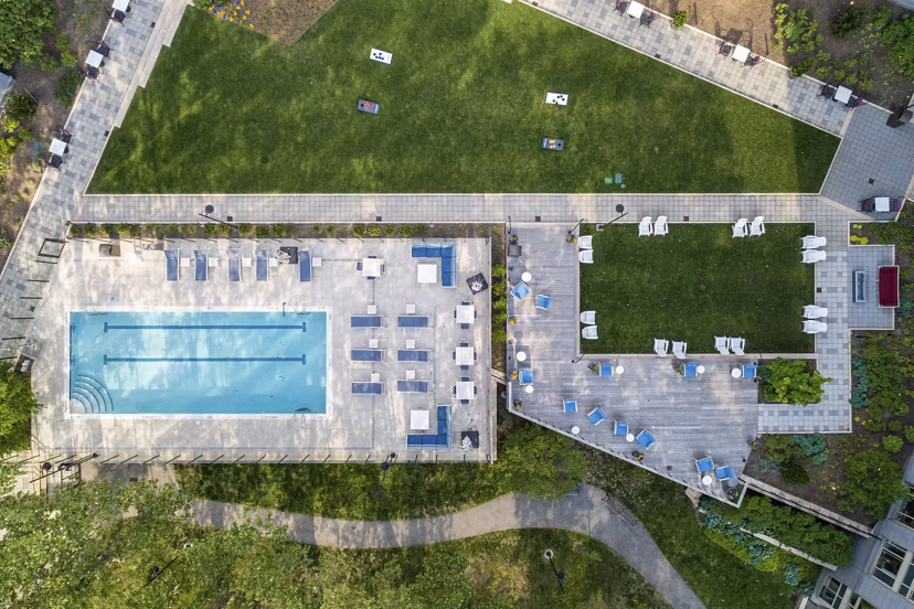 Sleek outdoor pool with lounge chairs at The Octagon Apartments, offering luxury living in a serene setting