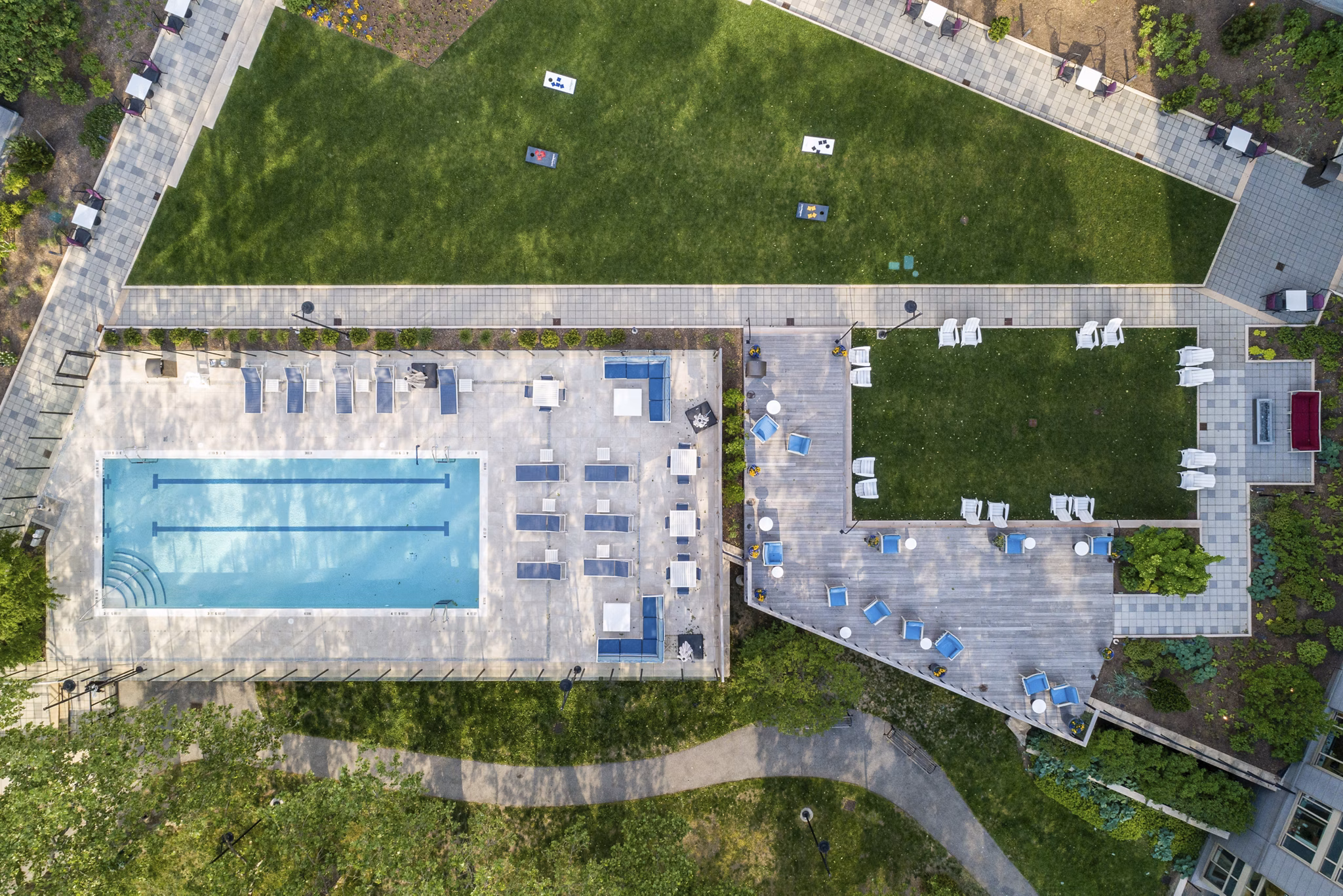 Sleek outdoor pool with lounge chairs at The Octagon Apartments, offering luxury living in a serene setting