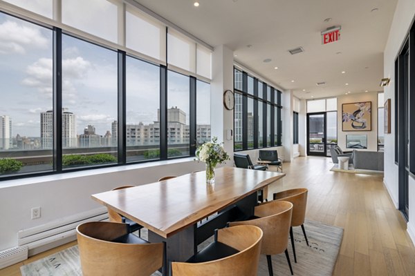 Oriana Apartments: Modern clubhouse equipped with luxury seating and stylish decor, perfect for community events