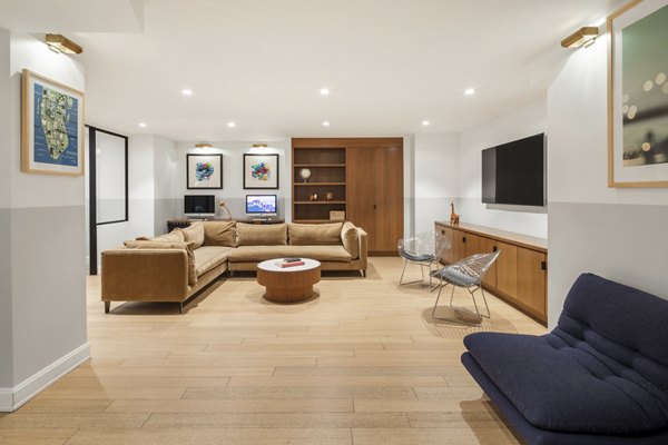 Modern clubhouse featuring spacious seating and a billiards table at Oriana Apartments, luxury living by Greystar in an upscale setting