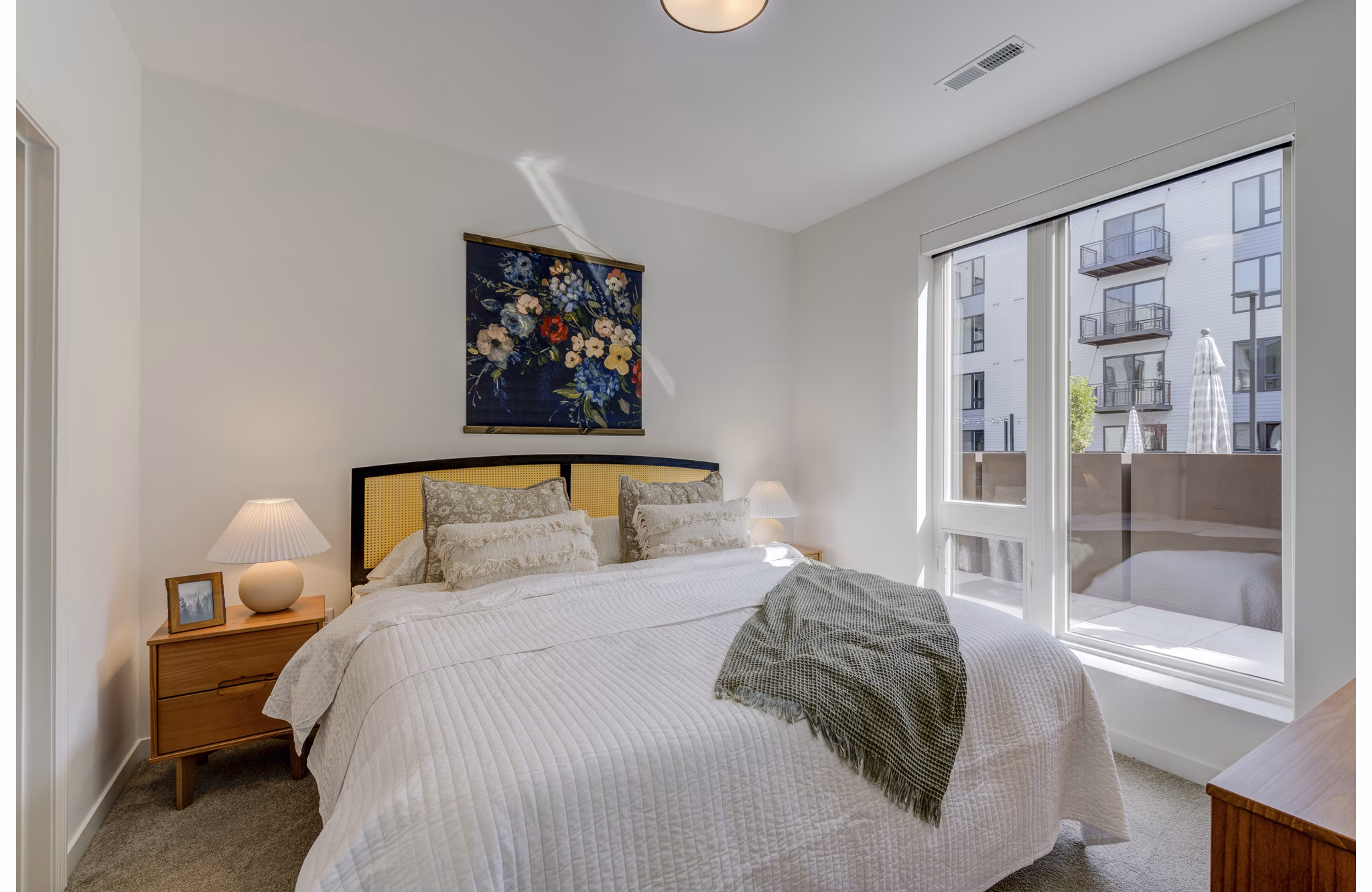 Cozy bedroom with modern furnishings at The James Apartments