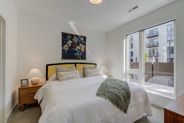 Cozy bedroom with modern furnishings at The James Apartments