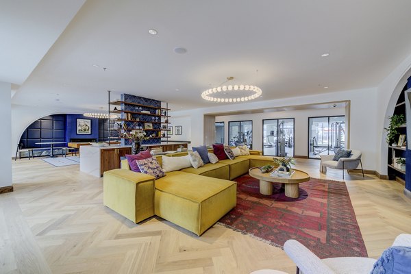 Clubhouse featuring modern furnishings and entertainment spaces at The James Apartments