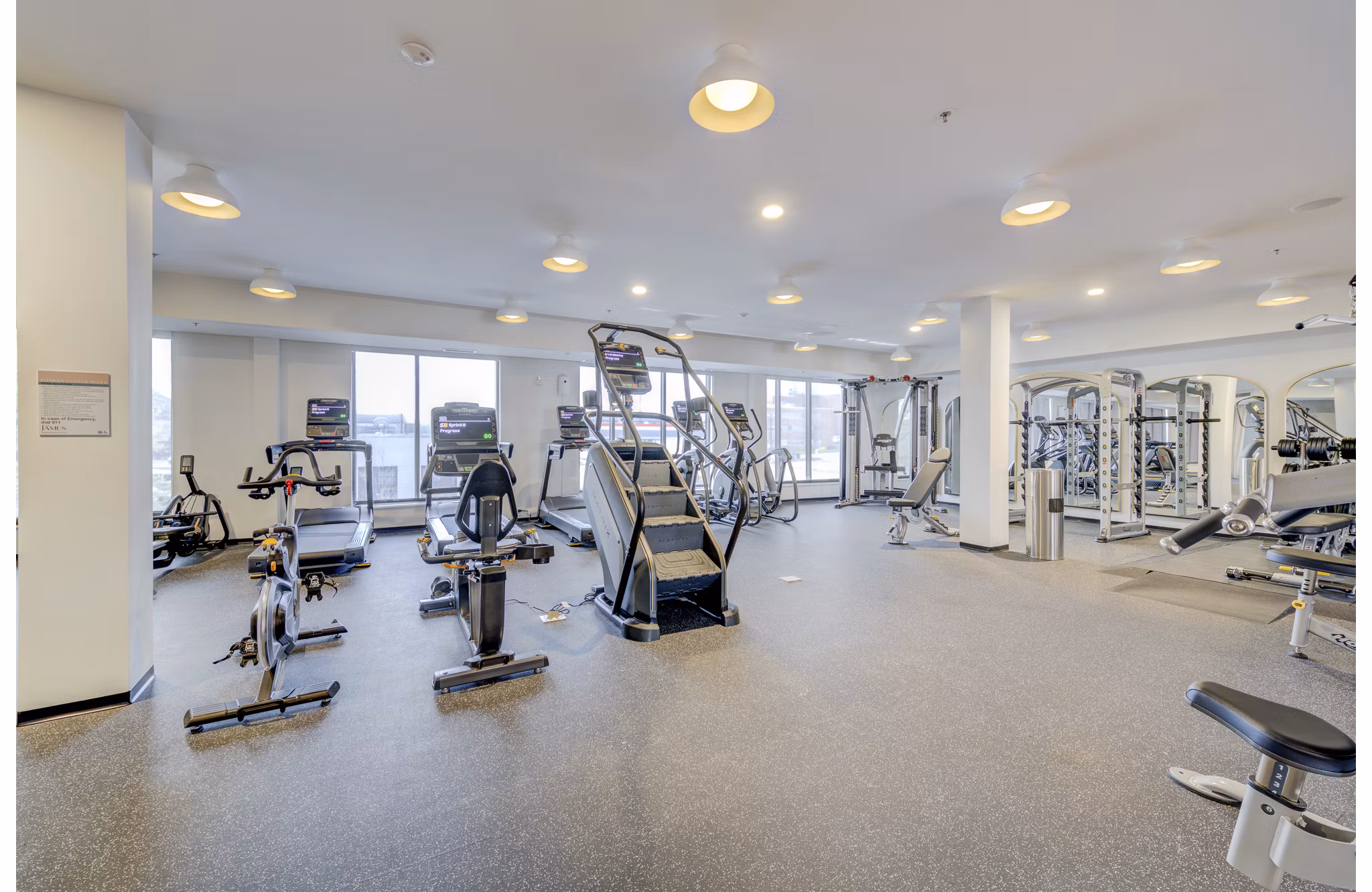 Modern fitness center with state-of-the-art equipment at The James Apartments