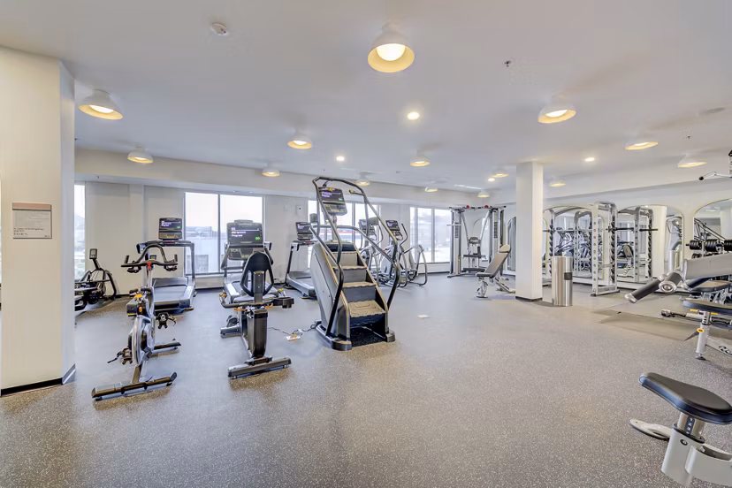 Modern fitness center with state-of-the-art equipment at The James Apartments