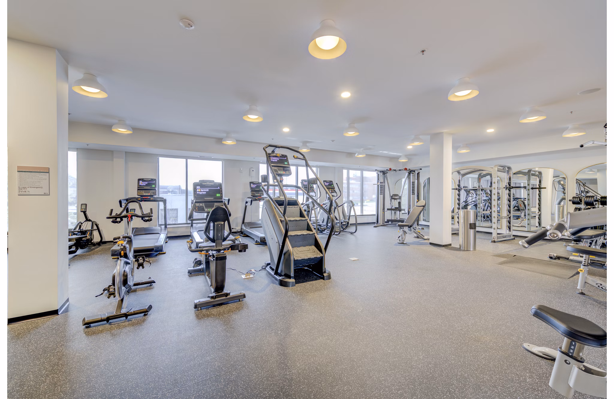 Modern fitness center with state-of-the-art equipment at The James Apartments