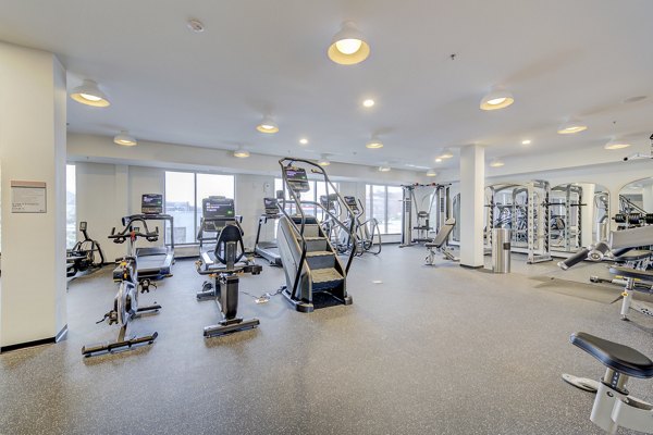 Modern fitness center with state-of-the-art equipment at The James Apartments