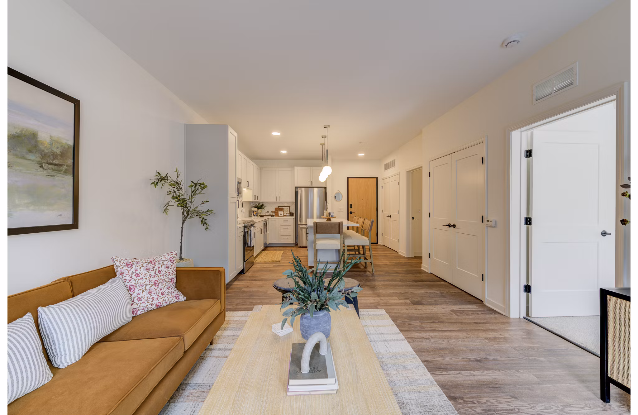 Stylish living room featuring modern decor and ample natural light at The James Apartments, offering luxury urban living spaces