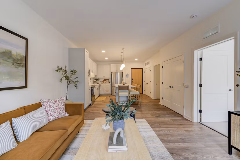 Stylish living room featuring modern decor and ample natural light at The James Apartments, offering luxury urban living spaces