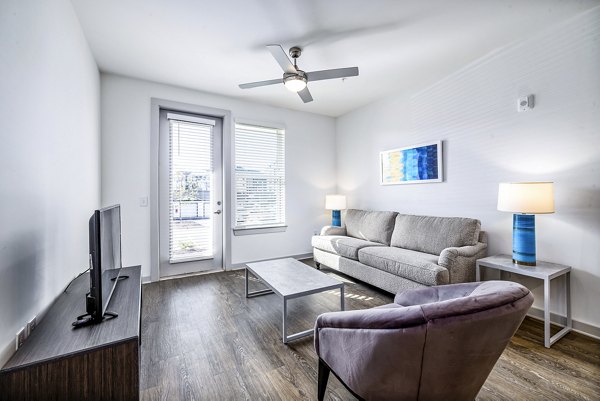 Spacious living room with modern decor at Arlow at Blue Ridge Apartments