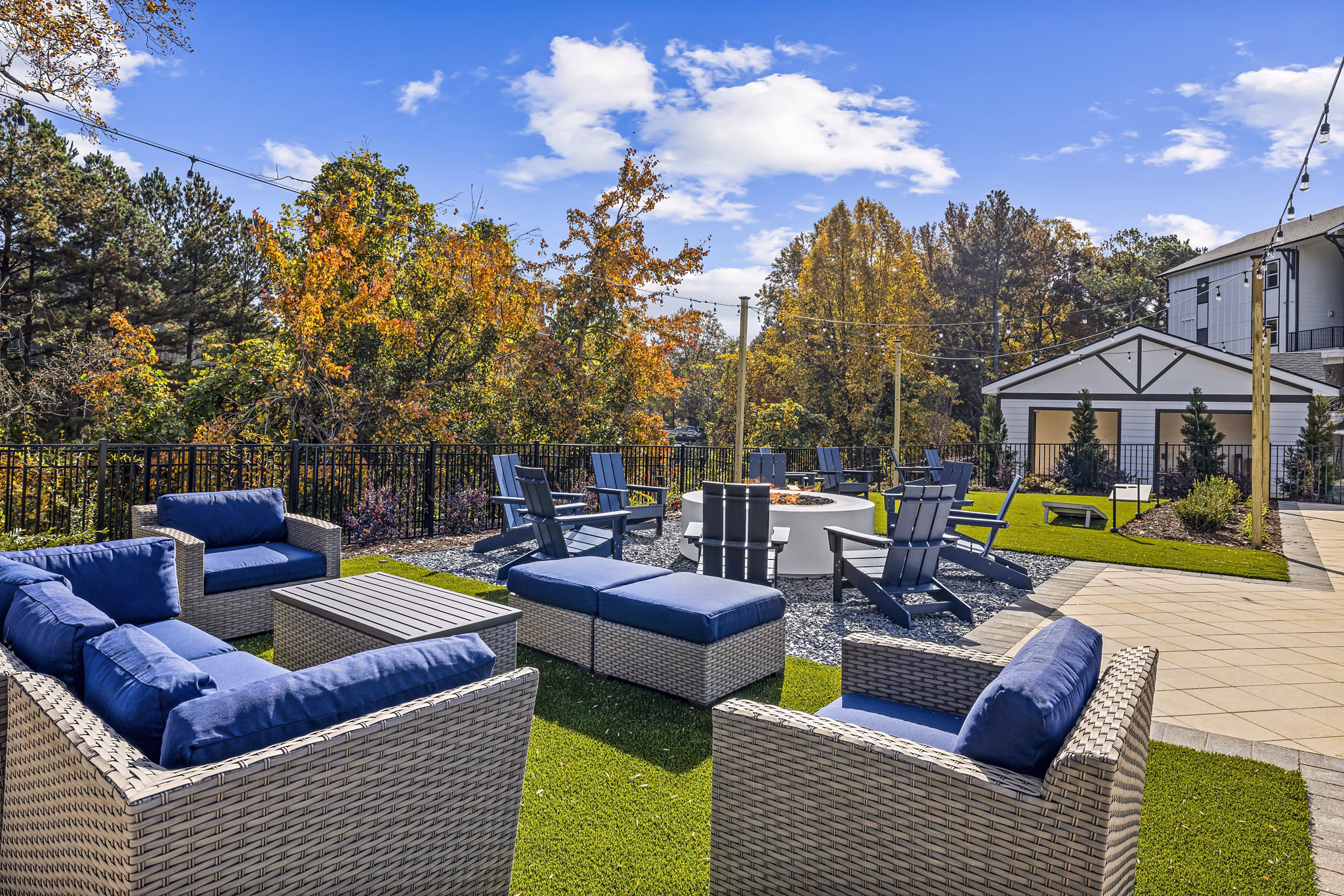 Fire pit and patio area at Arlow at Blue Ridge Apartments, offering luxury outdoor space in a serene setting