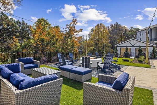 Fire pit and patio area at Arlow at Blue Ridge Apartments, offering luxury outdoor space in a serene setting