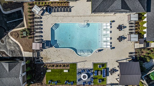 Resort-style pool surrounded by lush landscaping at Arlow at Blue Ridge Apartments, luxury living in a serene environment