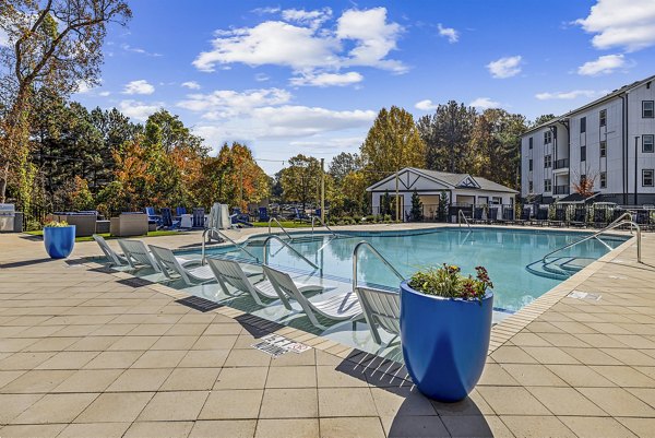 Resort-style pool at Arlow at Blue Ridge Apartments featuring lush landscaping and modern lounge seating
