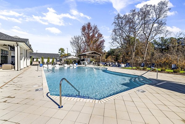 Resort-style pool with sundeck at Arlow at Blue Ridge Apartments, offering luxury community amenities in a serene setting