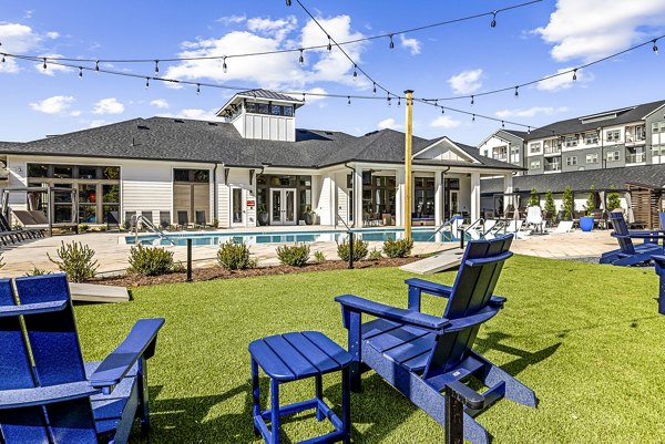 Aerial view of a luxurious pool surrounded by lush greenery at Arlow at Blue Ridge Apartments