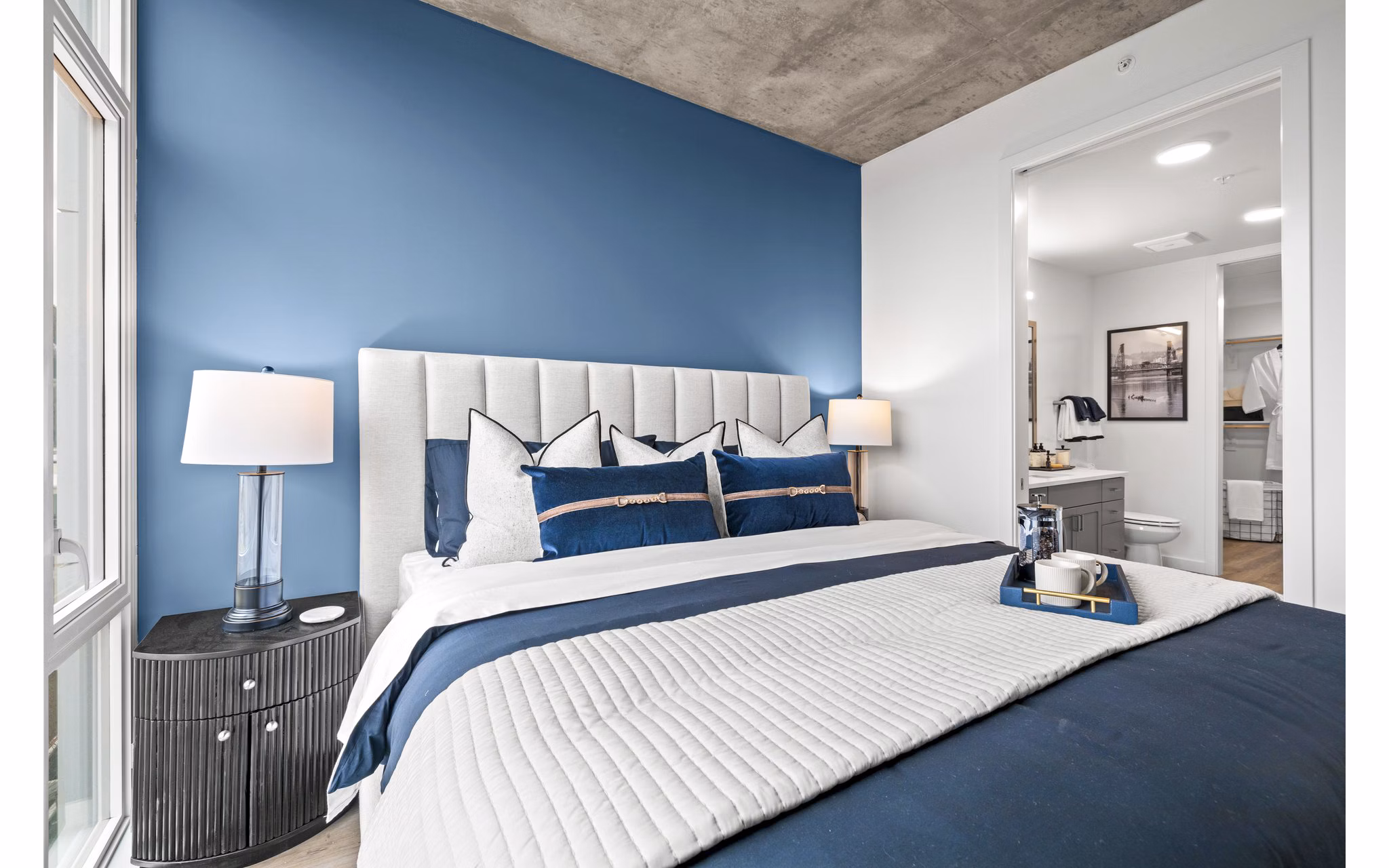 Contemporary bedroom with sleek furniture at Willamette Tower Apartments