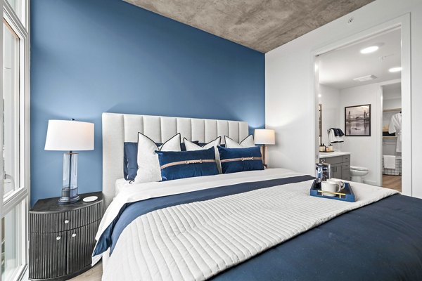 Contemporary bedroom with sleek furniture at Willamette Tower Apartments