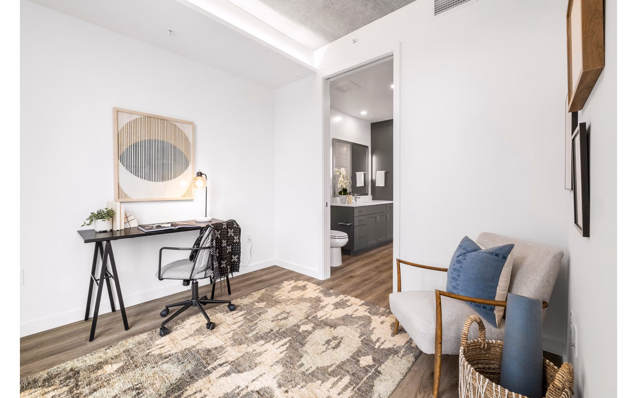 Modern bedroom/home office with ample natural light at Willamette Tower Apartments, perfect for luxury living and productivity in Portland